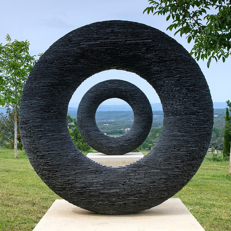 Spirit, a bespoke slate torus sculpture by James Parker, installed in a private landscape in the south of France.