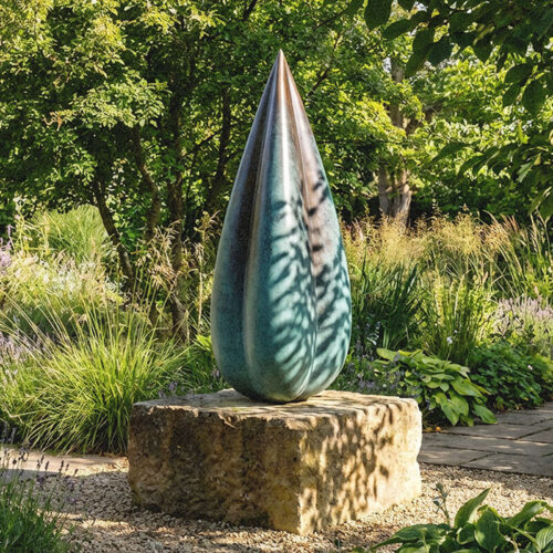 Five-foot bronze Bud sculpture by James Parker shown on a natural sandstone boulder in a garden visualisation