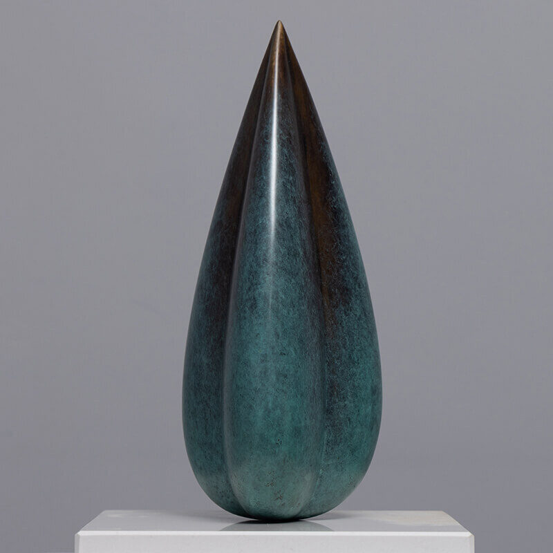 Front view of limited edition bronze Bud sculpture by James Parker displayed on a quartzite base in a gallery