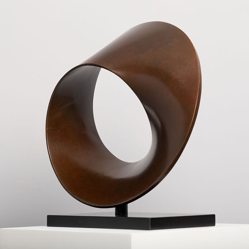 Oblique view of bronze Continuum sculpture by James Parker revealing evolving form