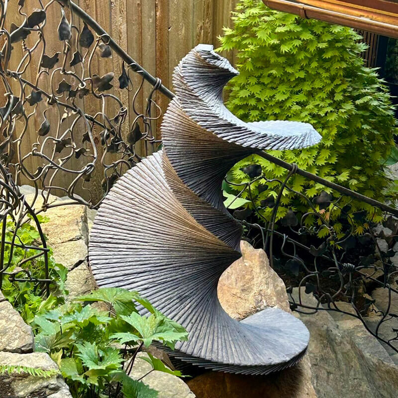 DNA of a Dancer stacked slate sculpture by James Parker installed in Whistler, British Columbia, Canada, highlighting international shipping and sensitive landscape installation.