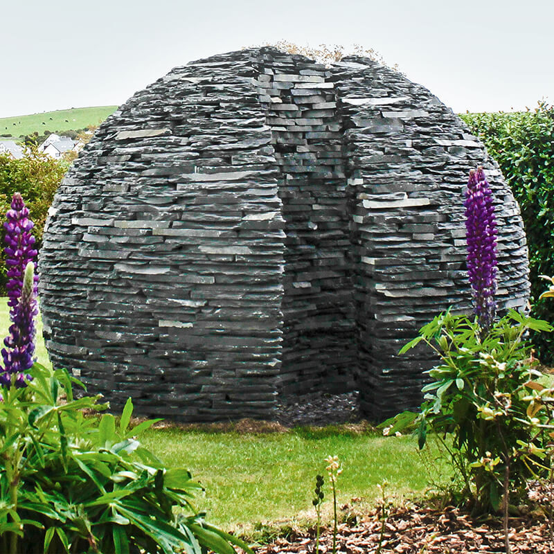 Everlasting Embrace monumental slate memorial sculpture by James Parker, formed as a divided sphere with a walk-through passage.