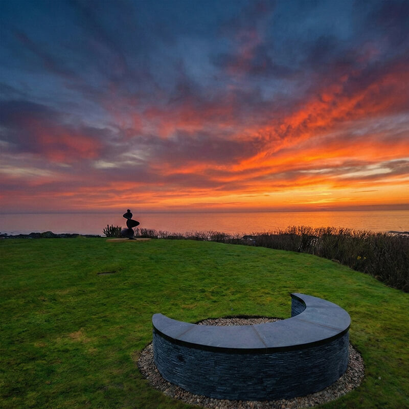 Moon Seat sculptural slate bench by James Parker, crescent-shaped outdoor seating formed from reclaimed stone.