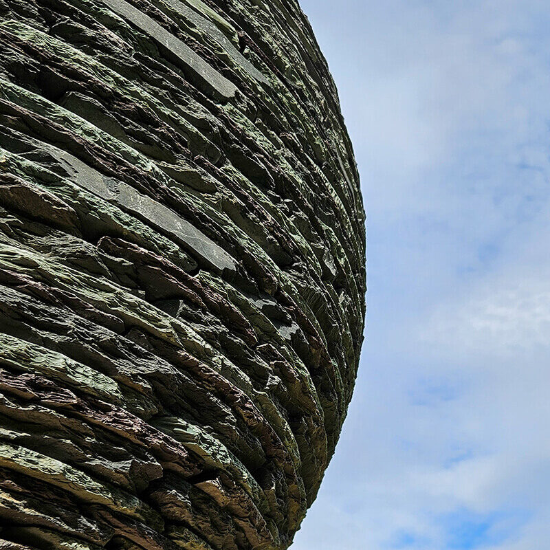 Close-up detail of layered slate showing natural striations and hand-stacked construction within a James Parker sculpture.