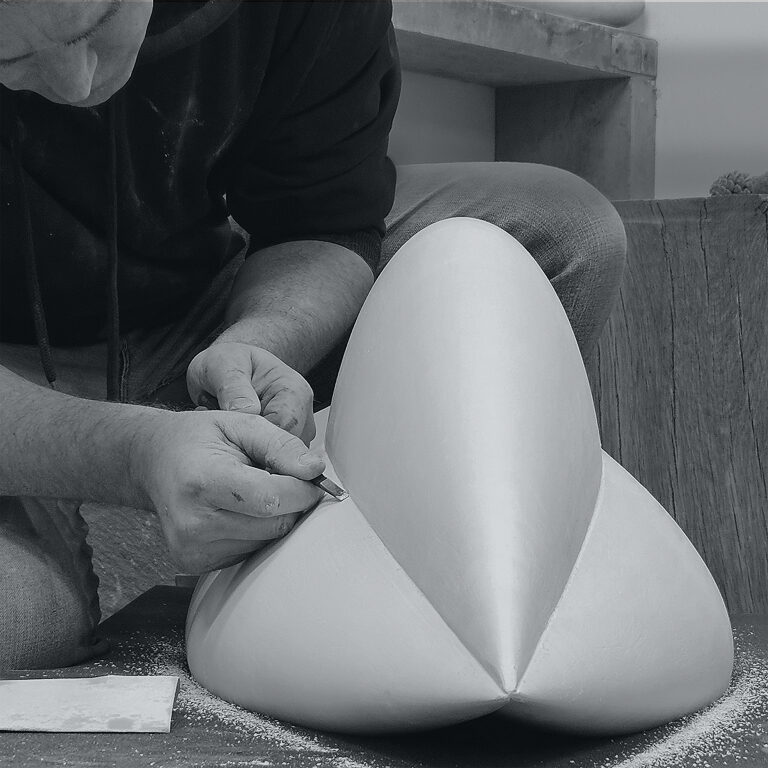 James Parker refining a plaster pattern in his workshop, preparing a sculpture for bronze casting.