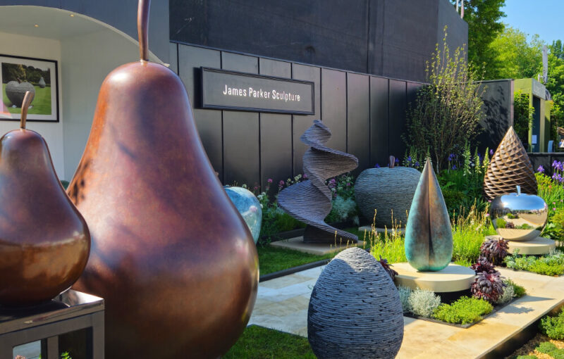 Sculpture garden setting at RHS Chelsea Flower Show 2024 with James Parker works in bronze, slate and stainless steel on display